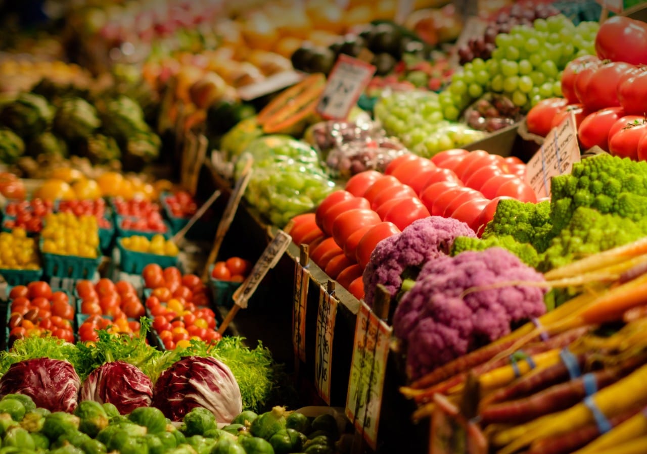 Rows of fresh vegetables in a grocery store.