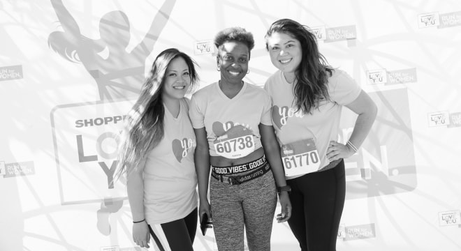 3 women in running outfits posing in front of Shoppers Love You background
