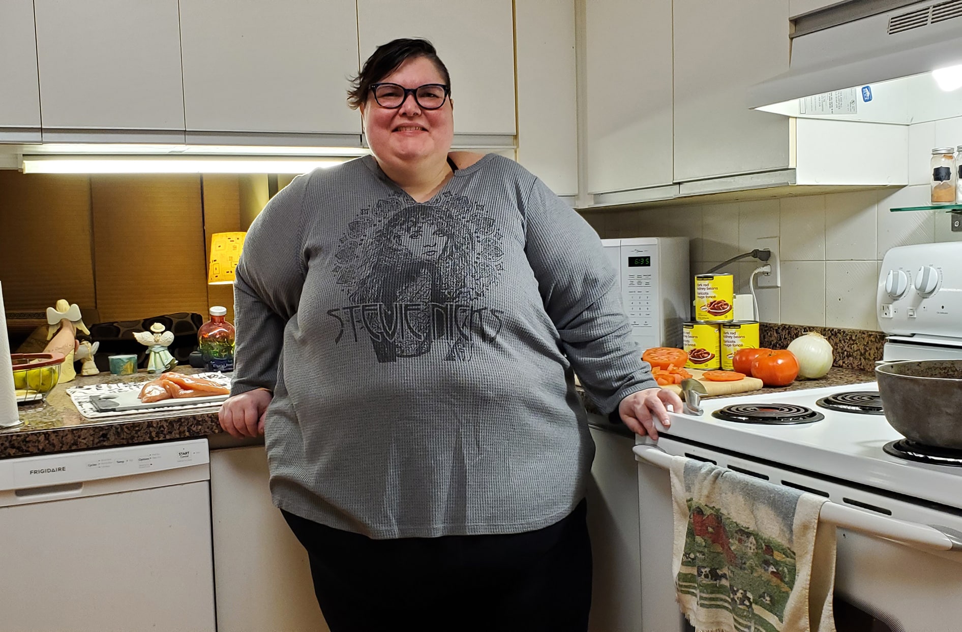 April stands inside her kitchen at home.