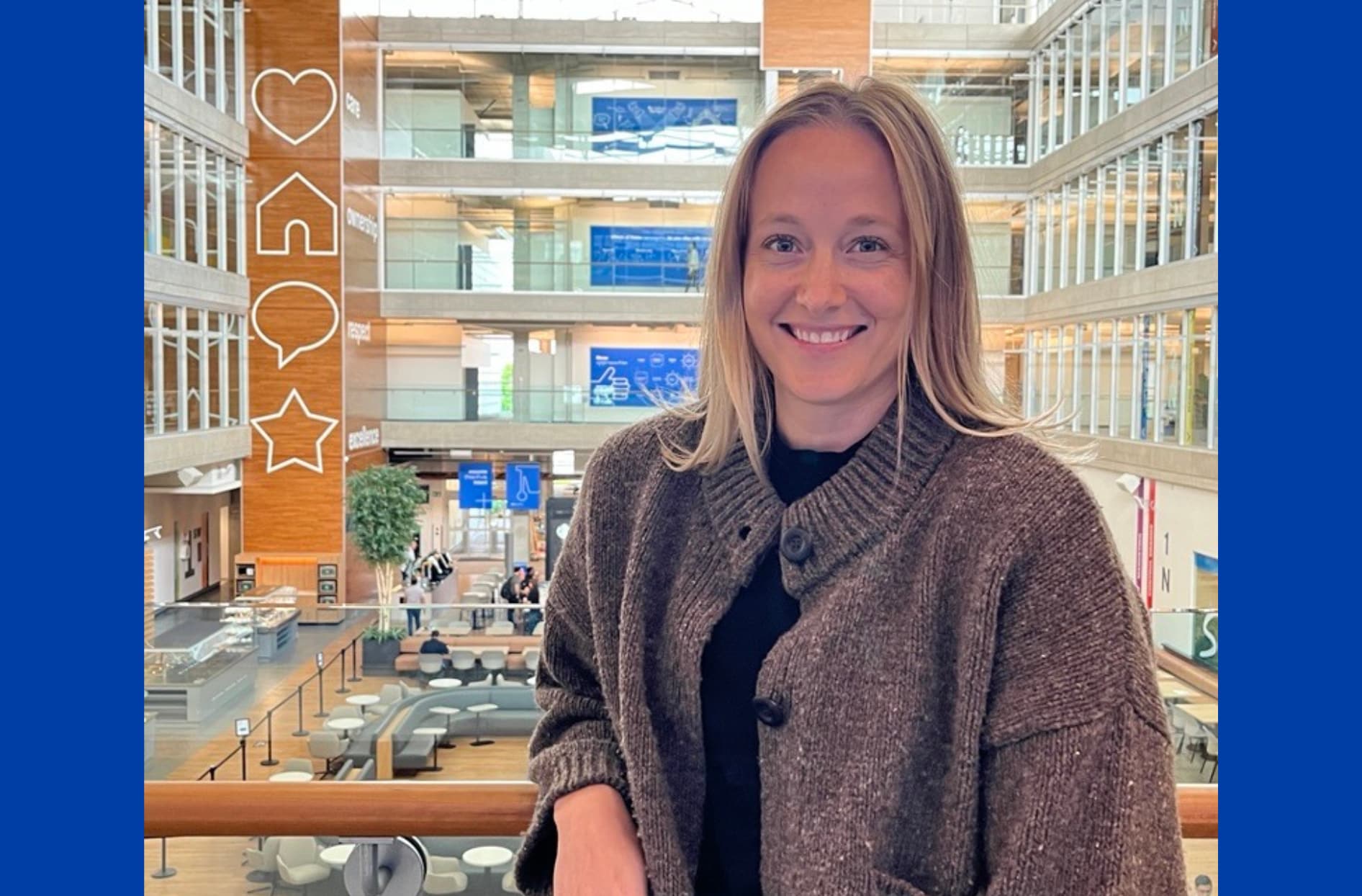 Briar standing by the railing inside of 1 President's Choice Circle, Loblaw’s head office in Brampton, Ontario.