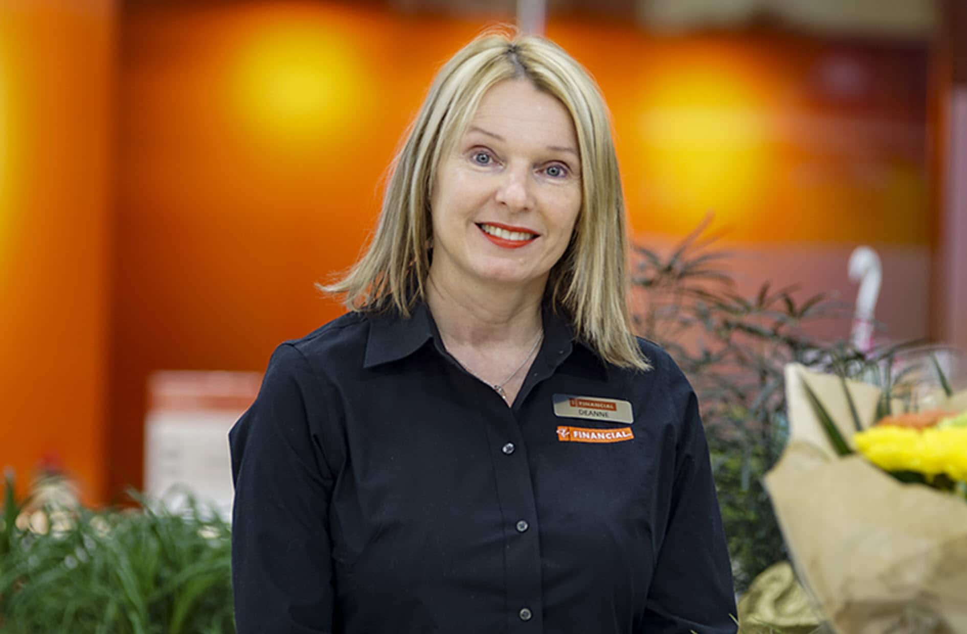 Deanne smiles wearing her new PC Financial uniform.