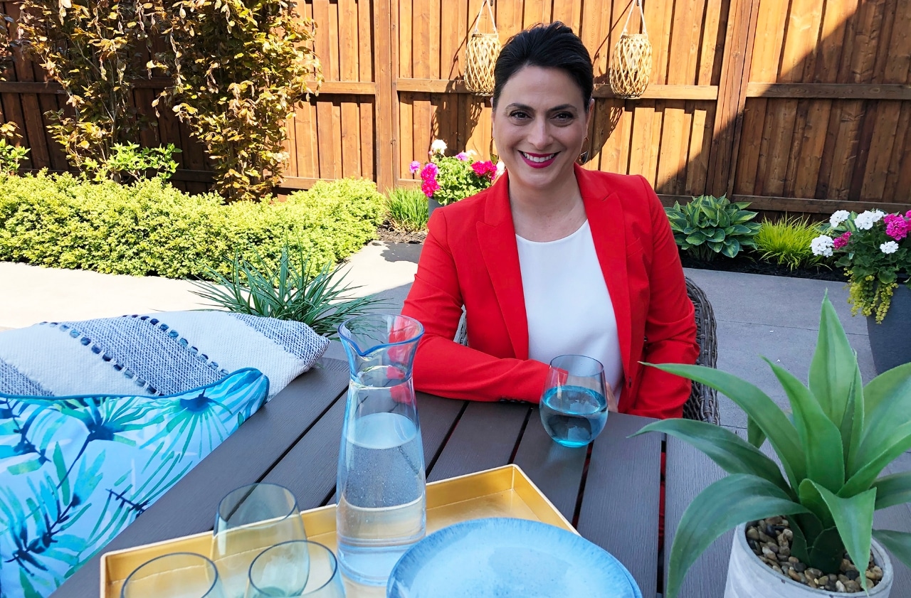 Smiling woman sitting in backyard 