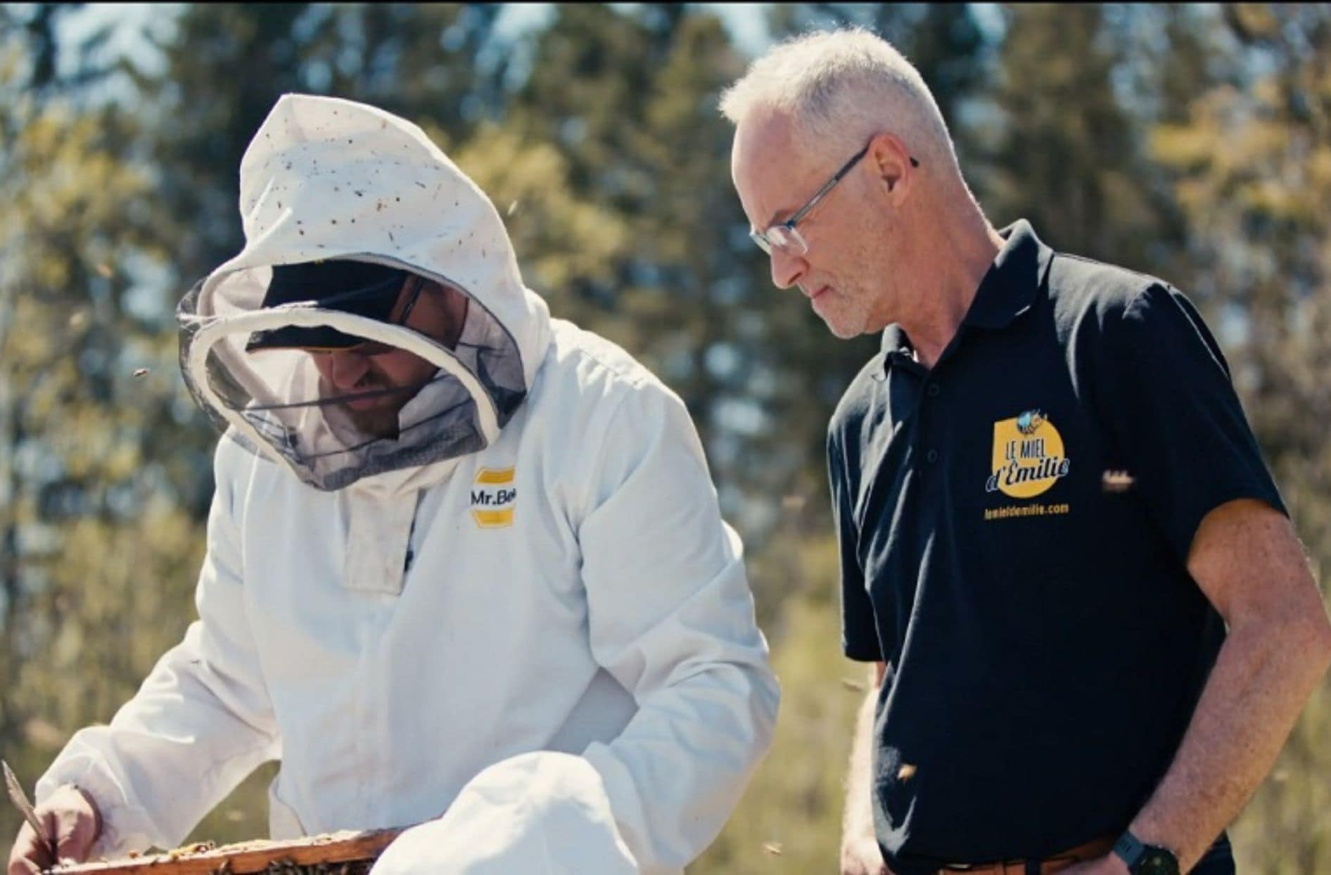 The business owner and a beekeeper at work.