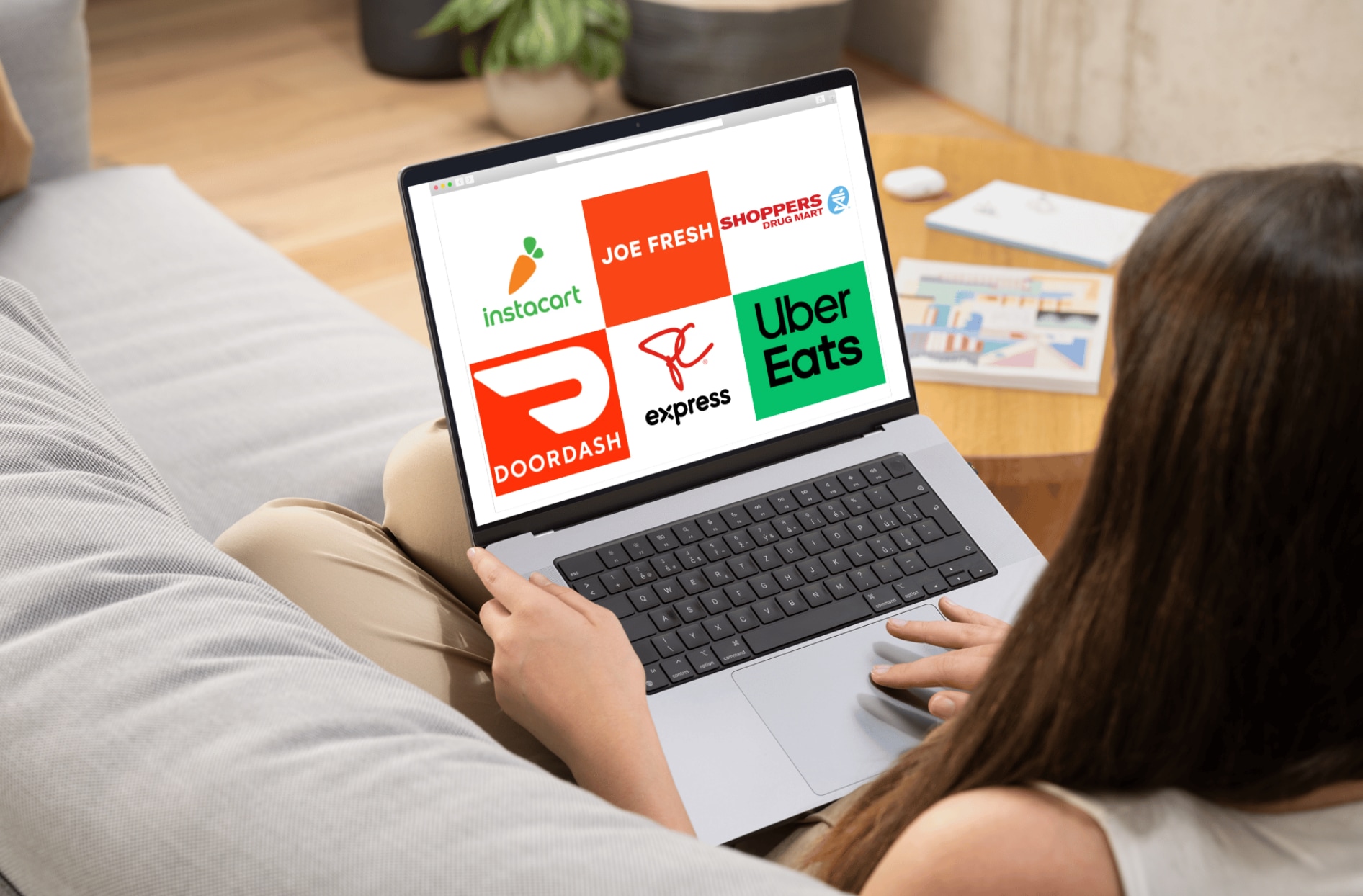 A person using a laptop exploring online shopping and delivery options, including Instacart, Joe Fresh, Shoppers Drug Mart, DoorDash, PC Express and Uber Eats.