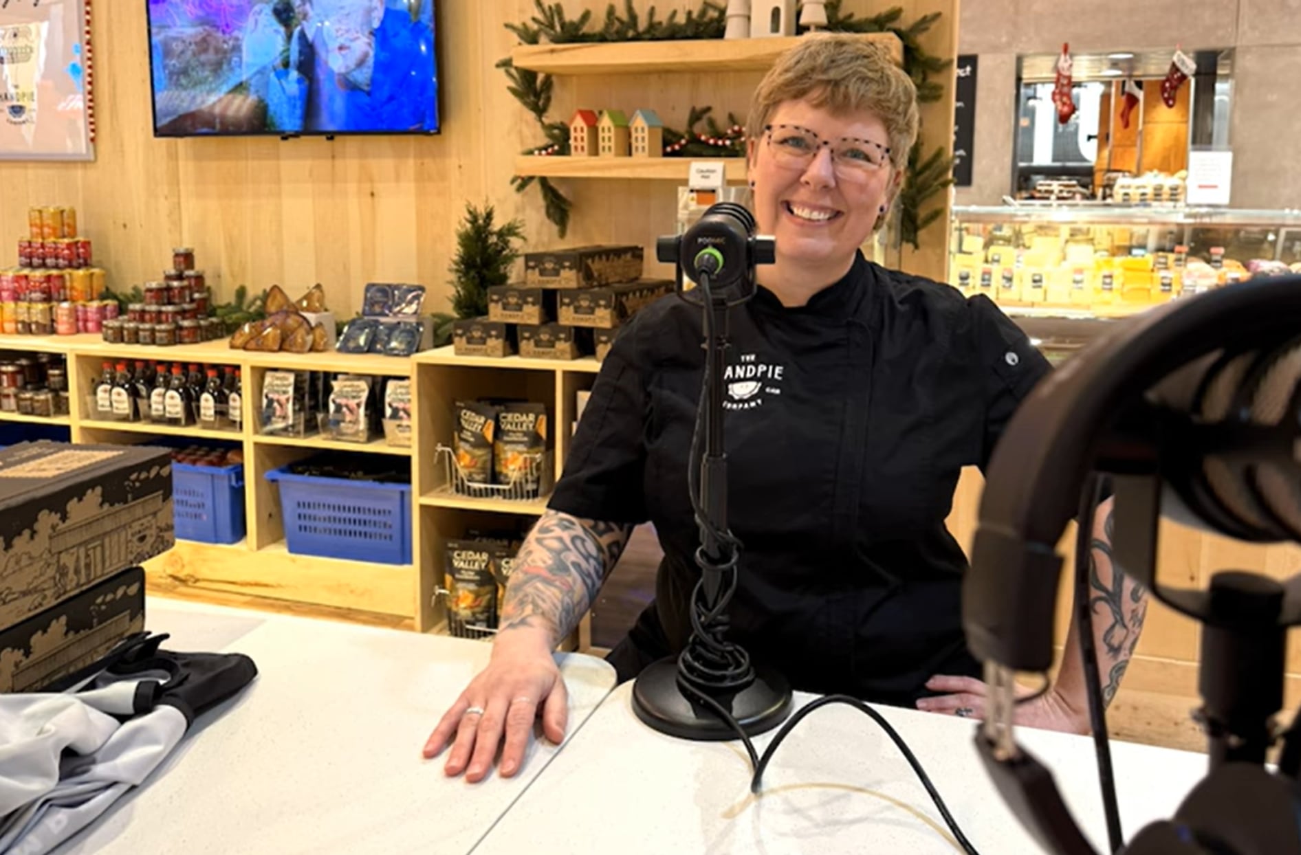 A photo of Handpie founder Sarah sitting down at a table in front of a mic.