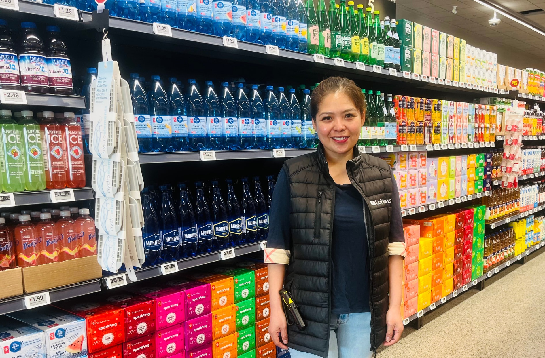 A photo of Christine standing inside the store in front of a shelf of products