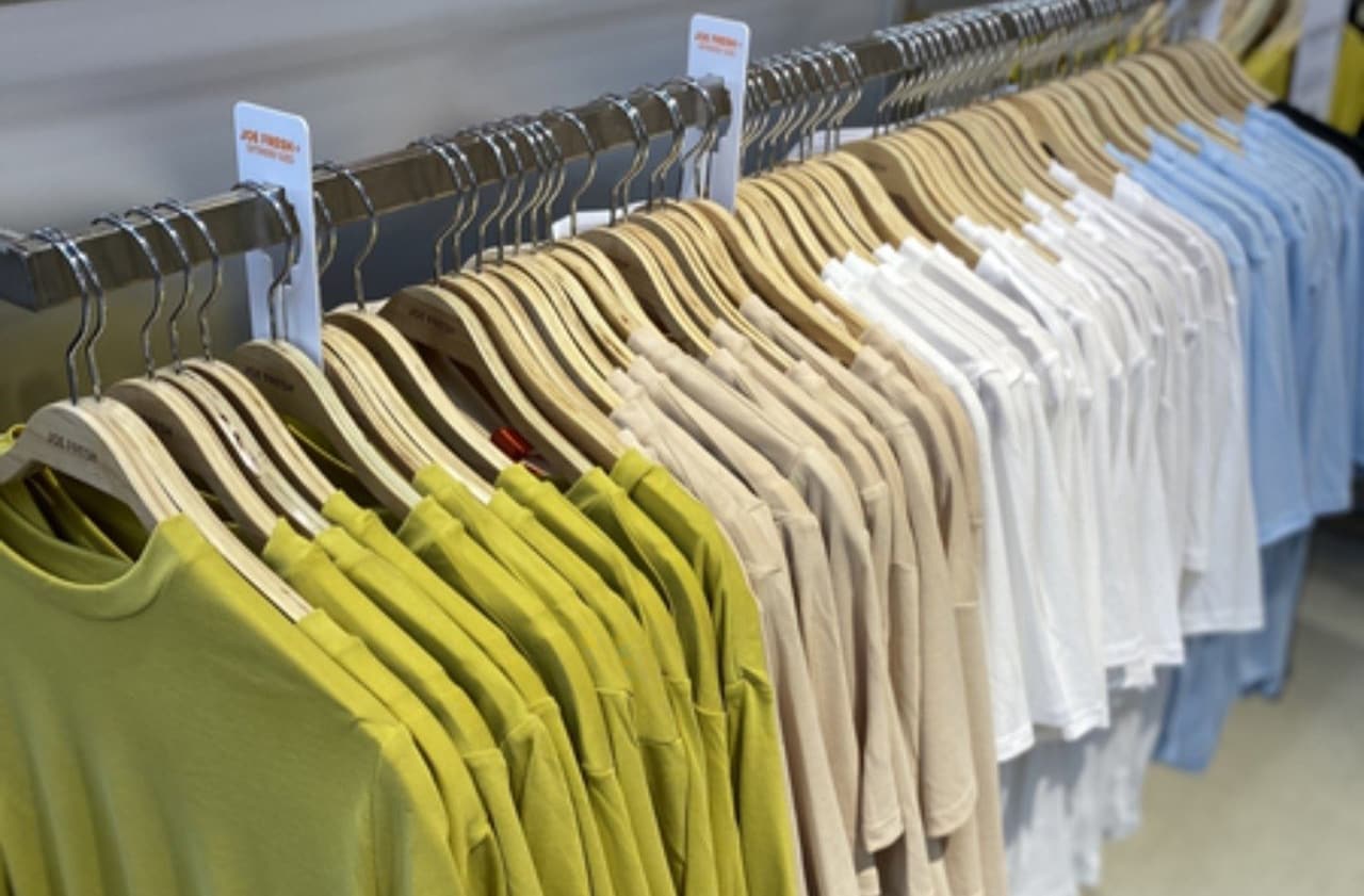 Clothes hanging on wood hangers 