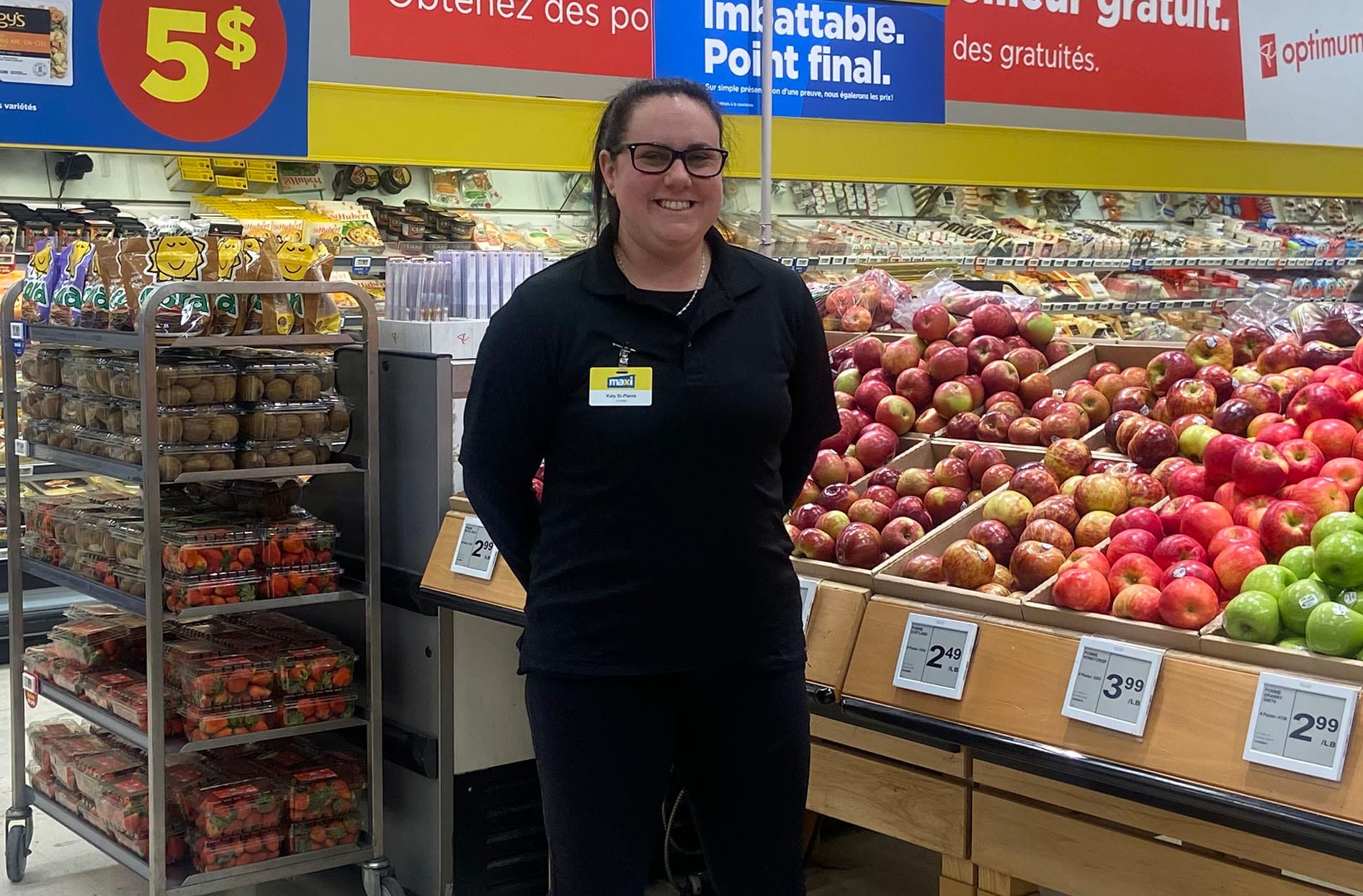 Kathy stands inside her store in the produce section.