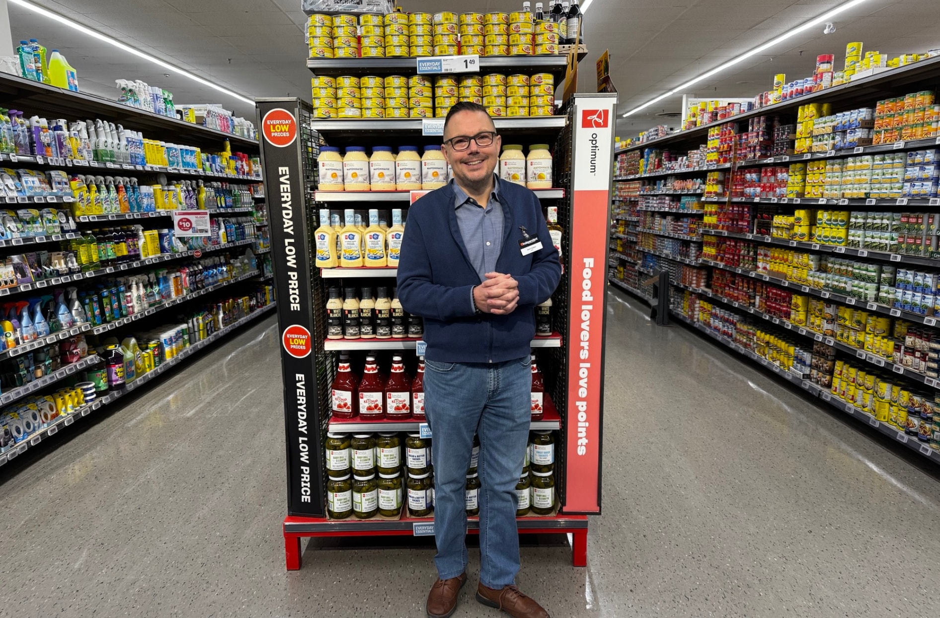 Kevin stands inside his store in the middle of two aisles. 