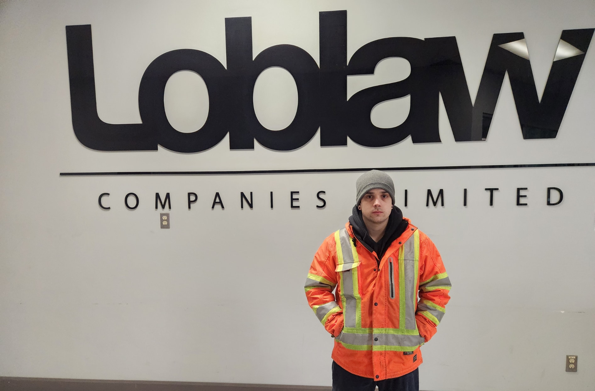 Matthew pictured in front of a Loblaw Companies Limited sign