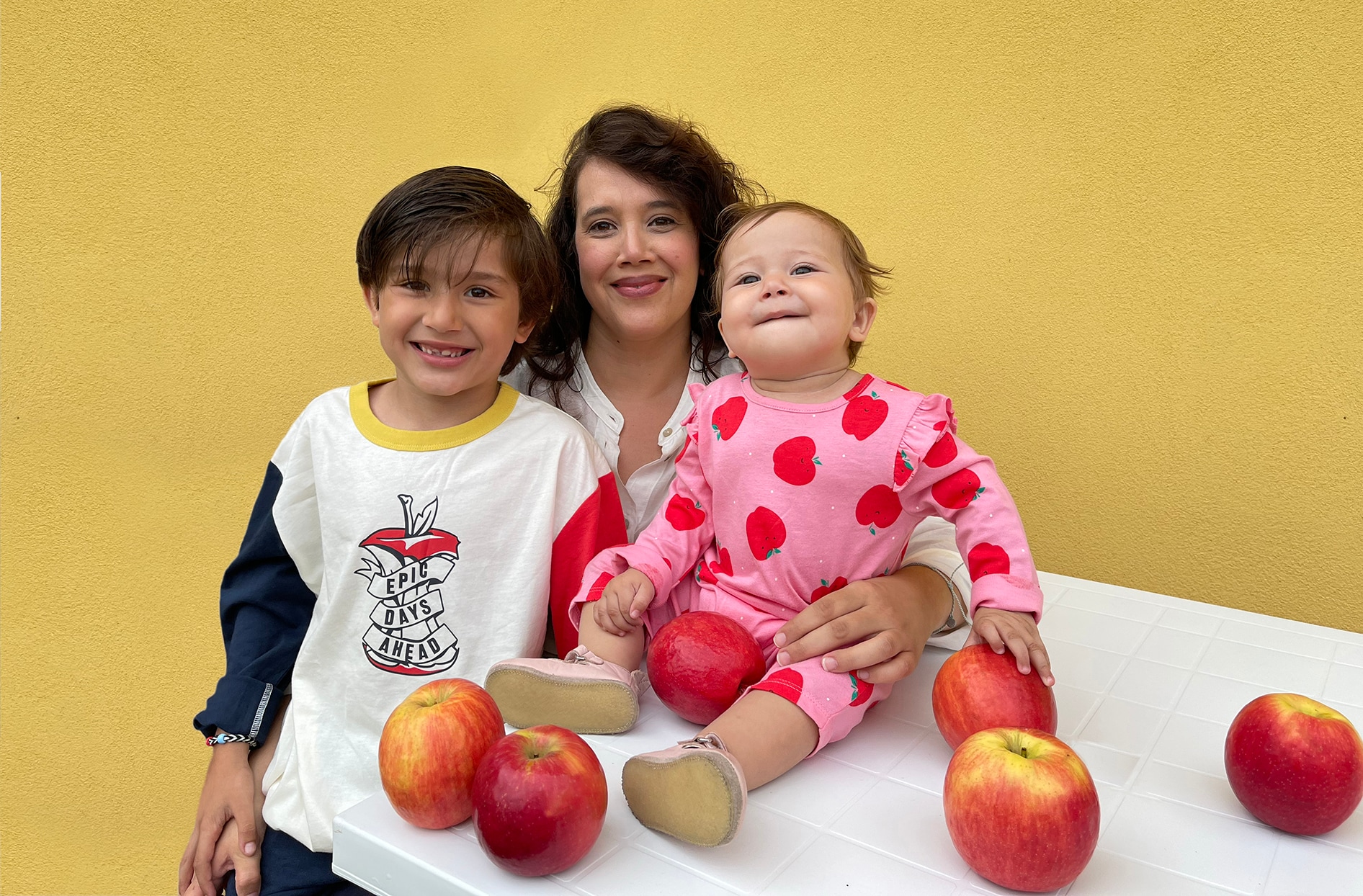 Olga sits with her two kids who are both wearing the new pieces from the back to school Joe Fresh and President’s Choice Children’s Charity campaign. 