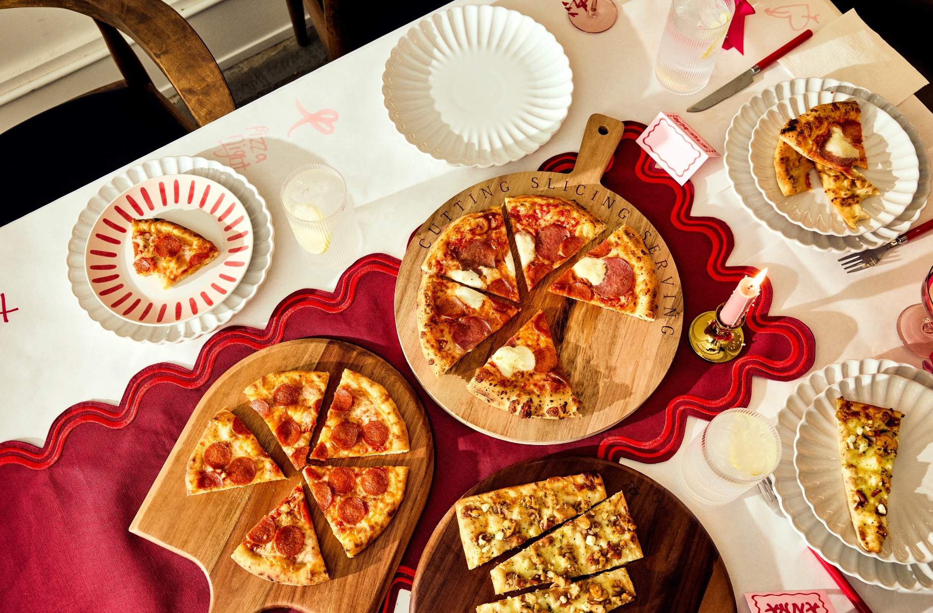 A dining table with pizza slices on plates