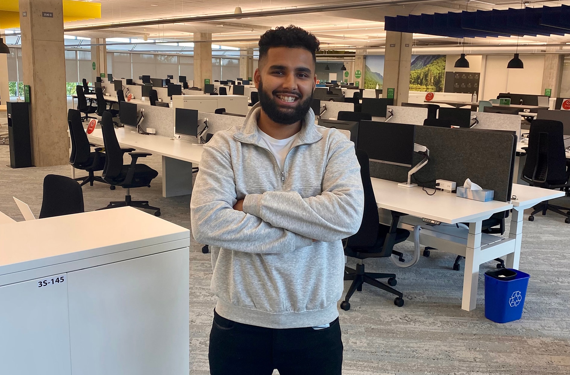 Rabie stands in front of desks inside Loblaw’s head office 