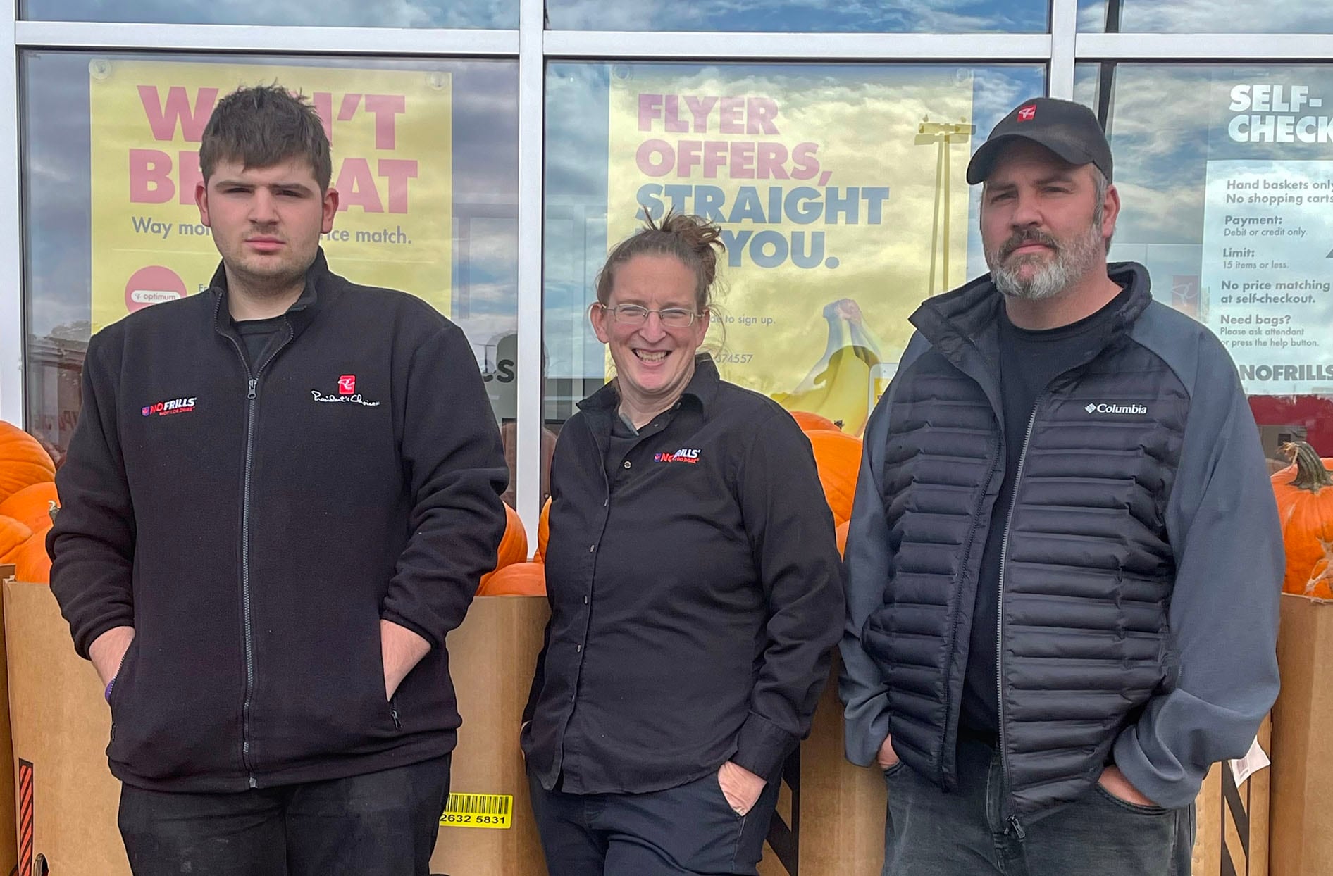 Shannon, Richard and their son Nathan stand inside a No Frills store. 