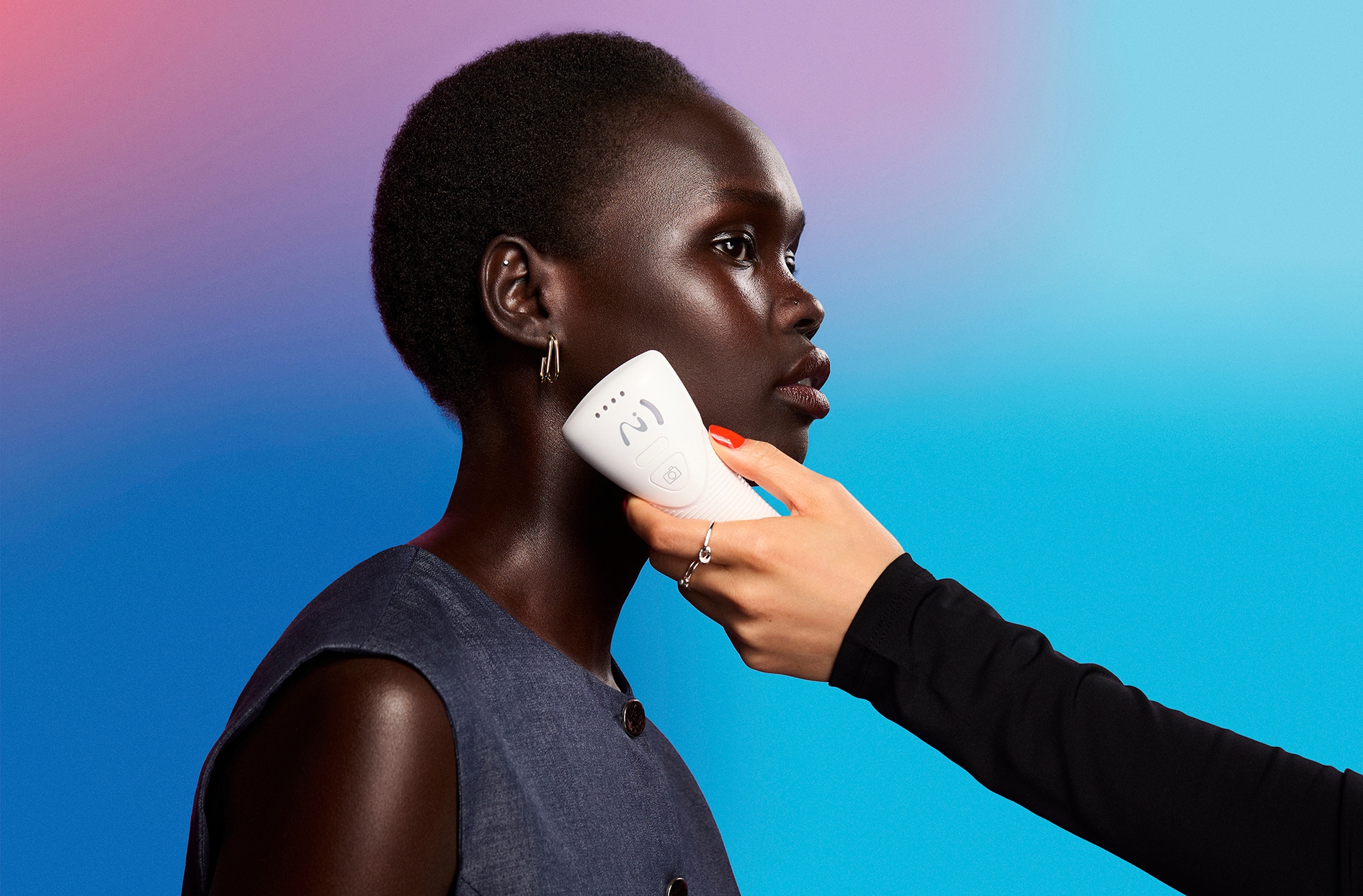A photo of a woman having the new skin analysis tool used on the side of her face.