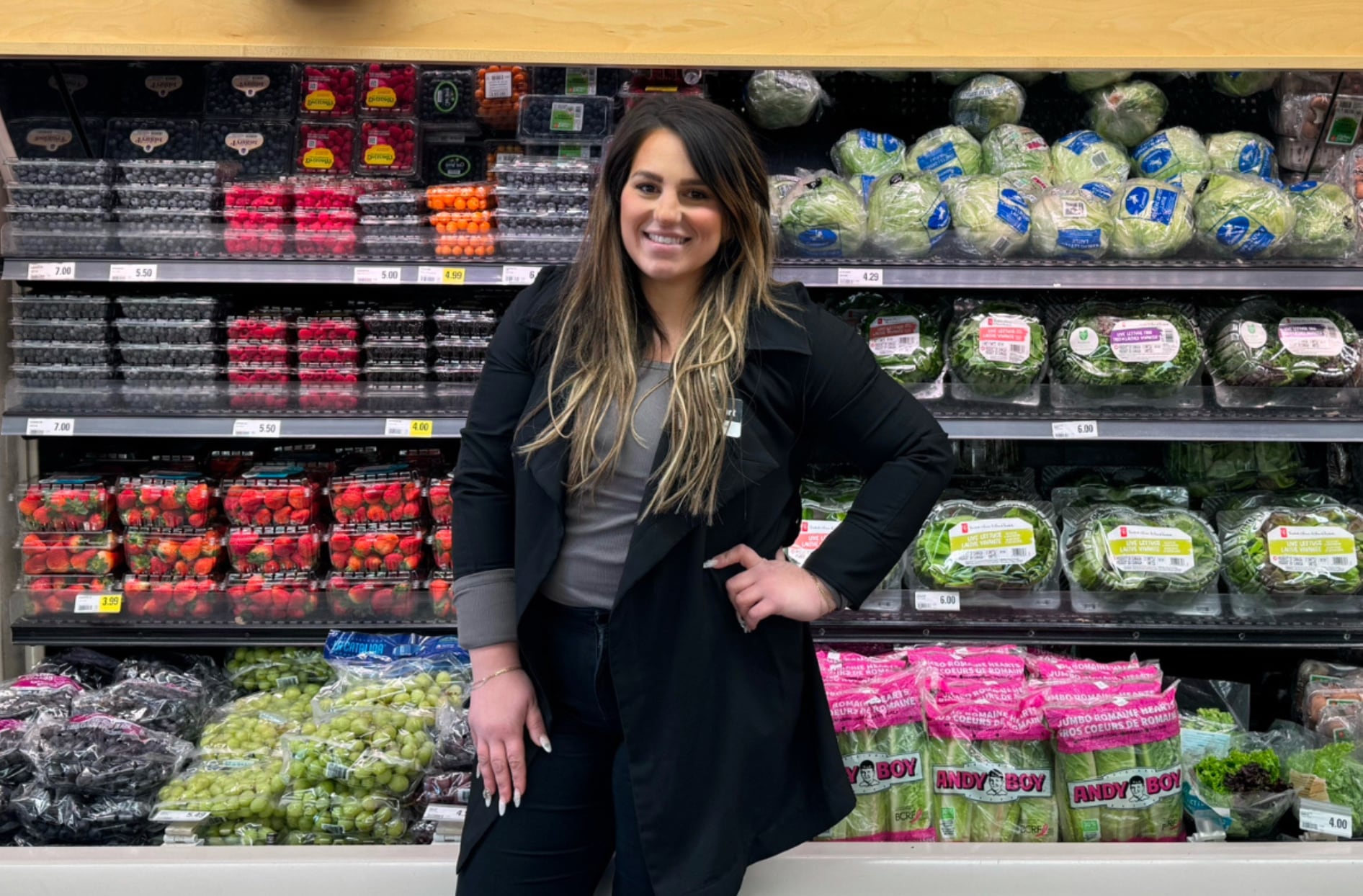 Stephanie stands and smiles inside a store.