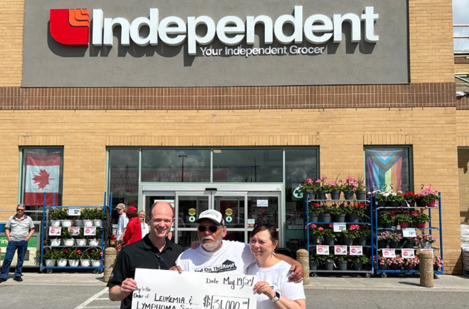 Morello’s Your Independent Grocer store owners David and Kimberley Morello smiling proudly alongside Ted Dawes after this year’s Ted on the Roof fundraiser in support of leukemia and lymphoma research. 