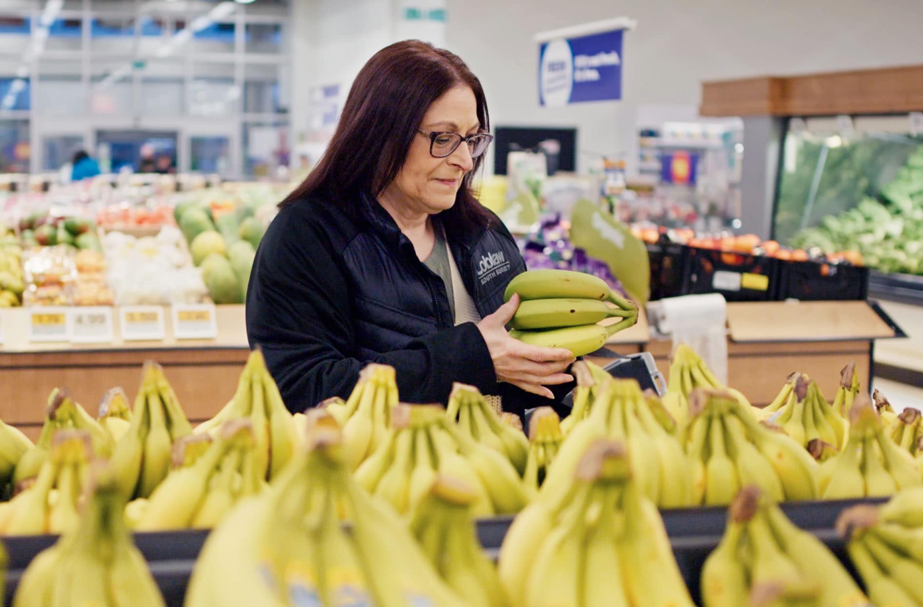 Quality Assurance Specialist Teresa Cerminara, carefully inspecting bananas in the produce section at one of our stores. 
