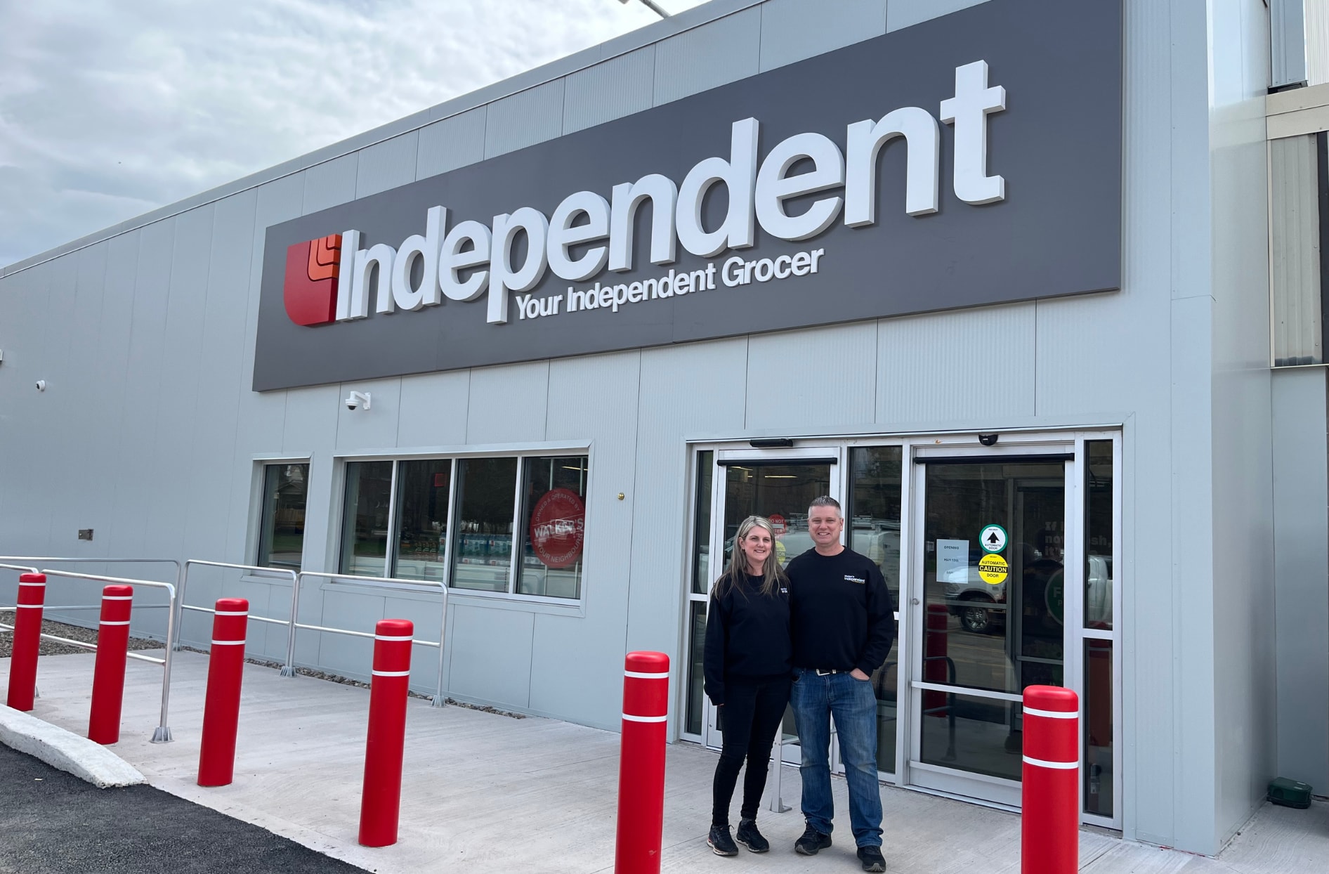 Store Owners James and Willow Walker standing outside a YIG grocery store.