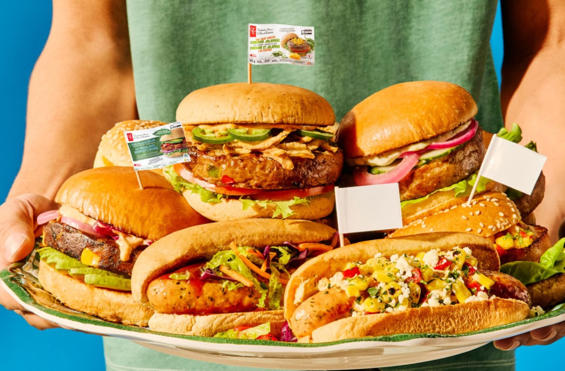 A photo of a platter of burgers and hot dogs featuring items from the PC® Summer Insiders Report.
