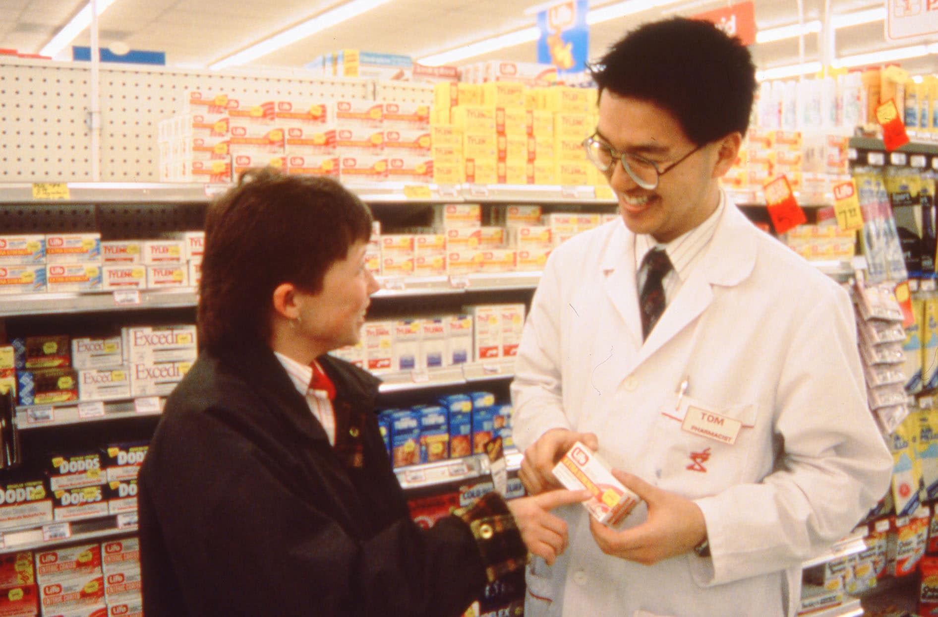 Pharmacist talking to customer 