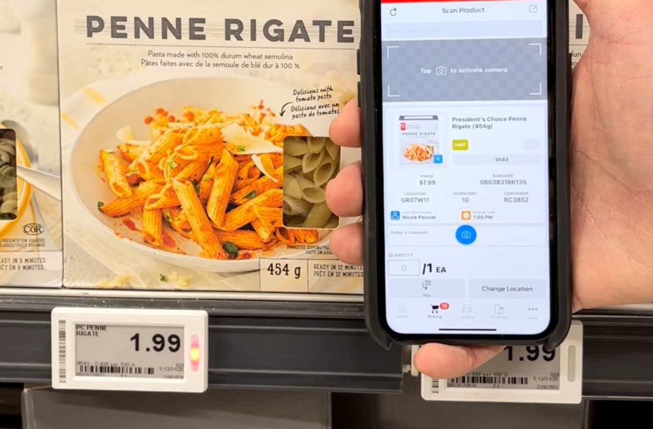 Device in front of a box of pasta with electronic lit-up label under it