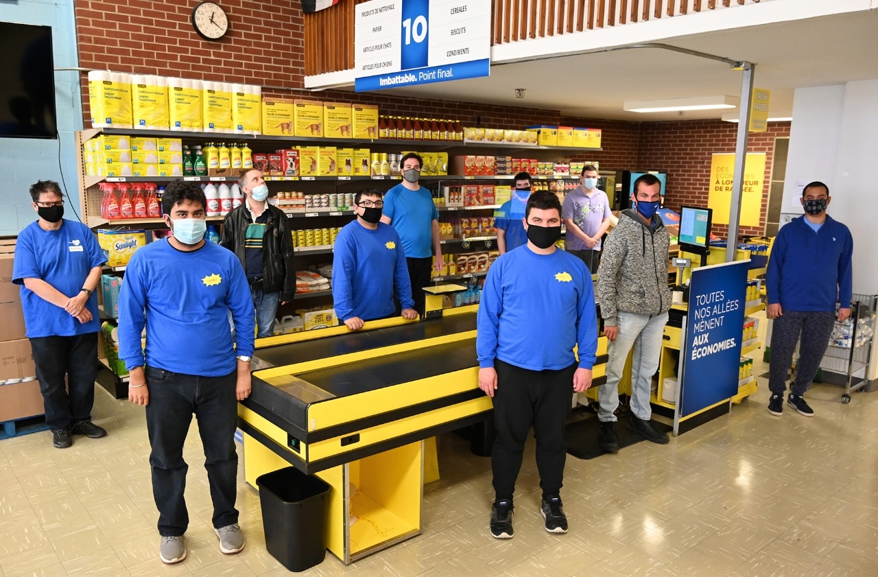 10 participants standing in small-scale version of grocery store