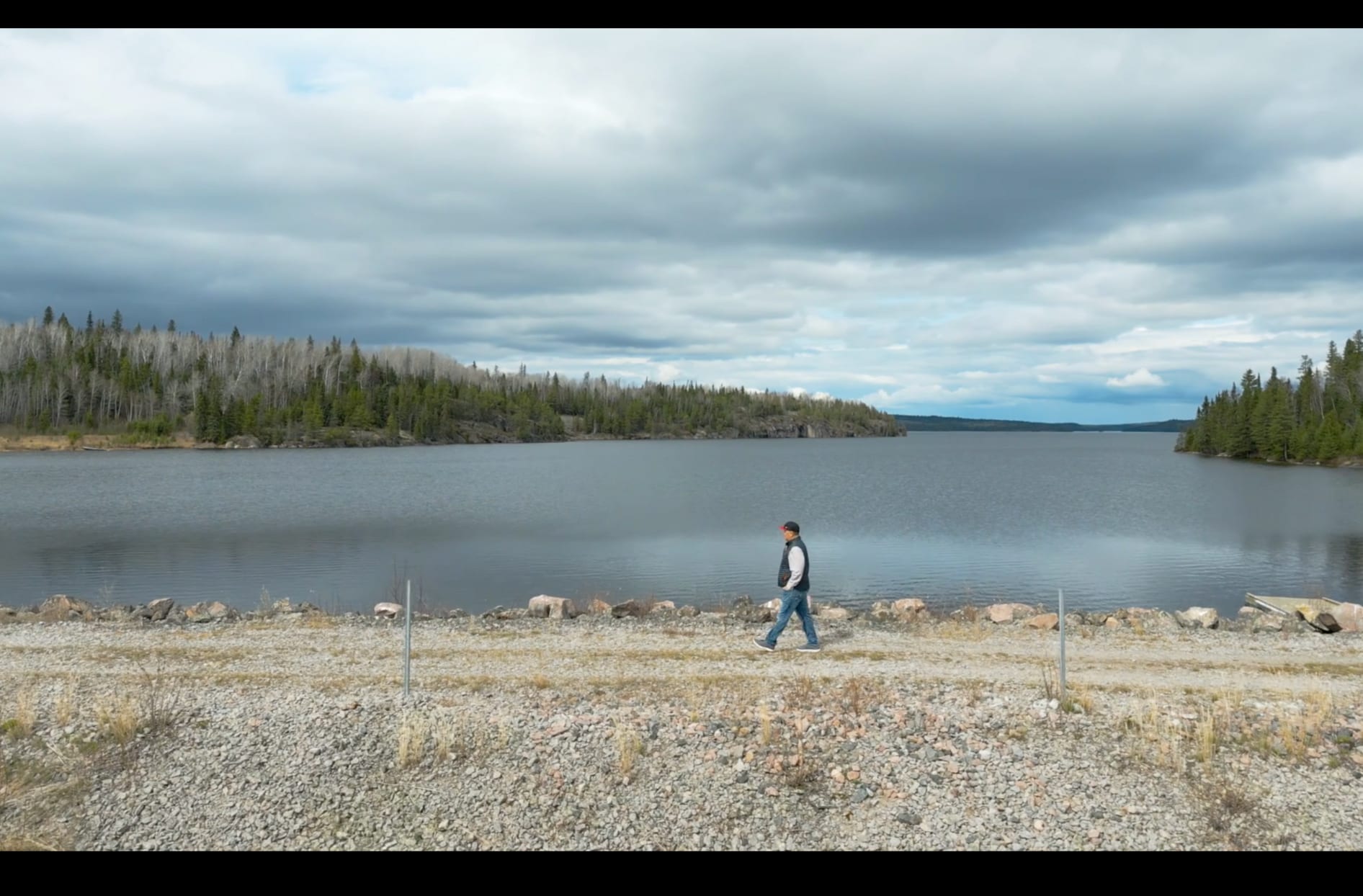 The community leader walks across the river in the community of Wabaseemoong in northern Ontario