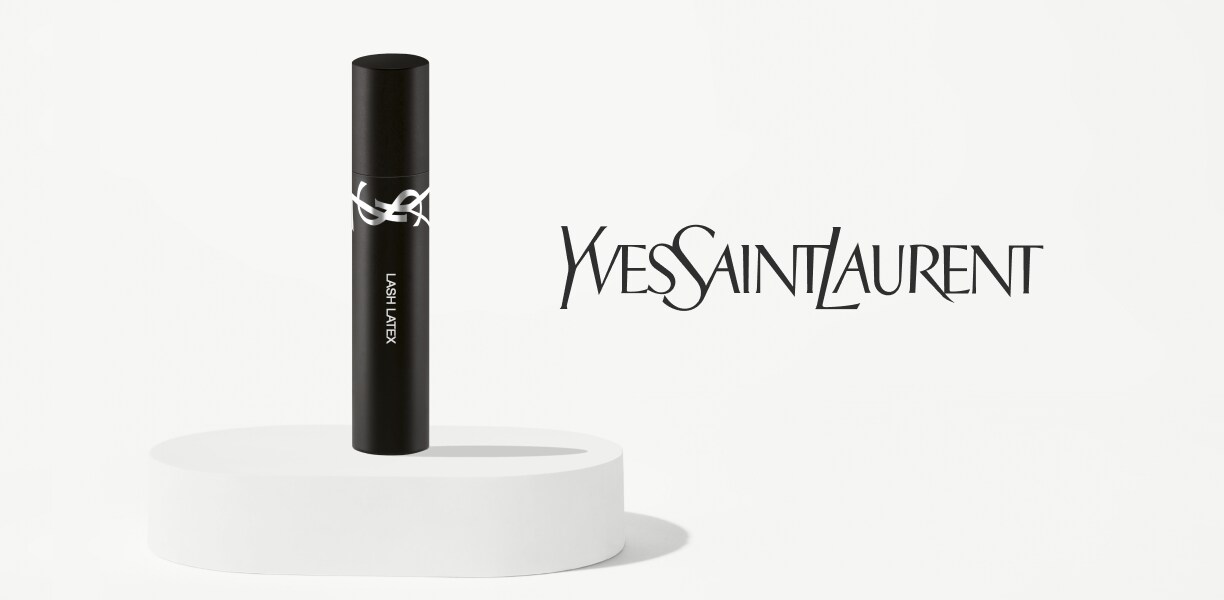 A mini tube of mascara on a white plinth next to the Yves Saint Laurent logo. 